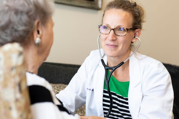 Healthcare professional consulting with a resident.