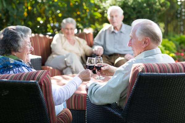Residents enjoying drinks together in an outdoor setting