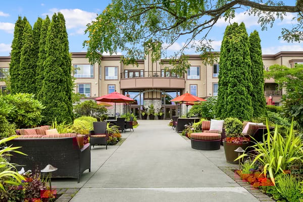Exterior view of a senior living facility with garden area