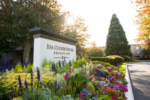 Entrance sign of Ida Culver House Broadview with flowers