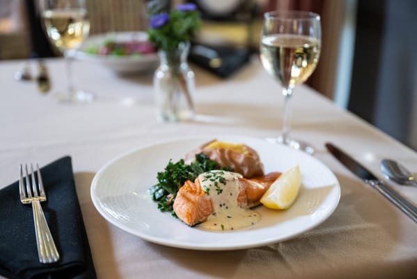 A plated gourmet meal with salmon and vegetables
