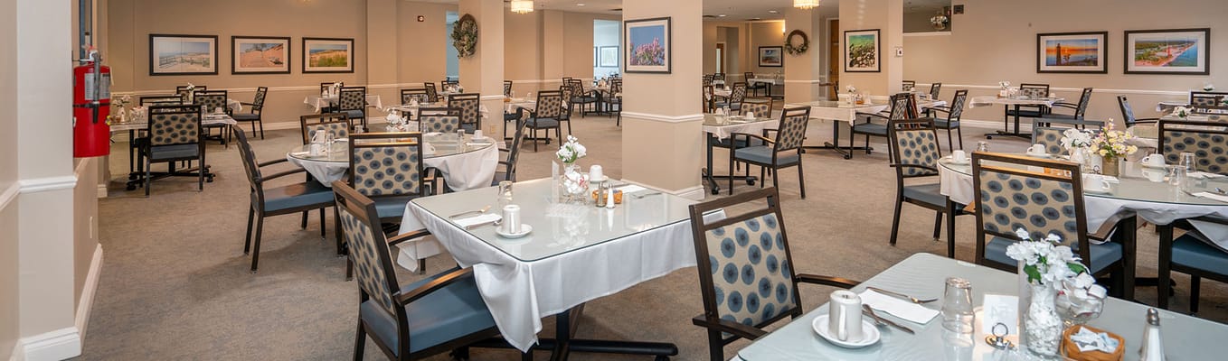 Bright dining room with tables set for meals