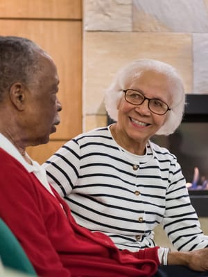 Two residents engaged in conversation in a common area