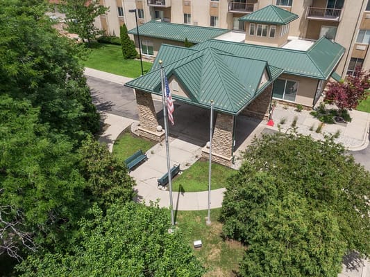 Aerial view of entrance with garden and flag