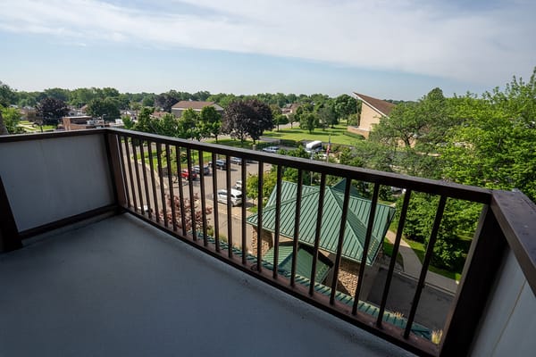 View from a balcony overlooking a green landscape