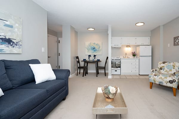 Cozy interior of a senior living unit with kitchen and seating area