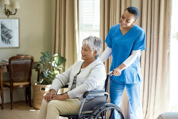 Caregiver assisting a resident in a bright room