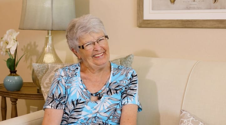 Senior resident smiling in a well-lit living area