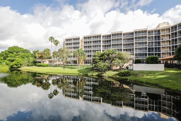 Exterior view of Sun Towers Retirement Community by a lake
