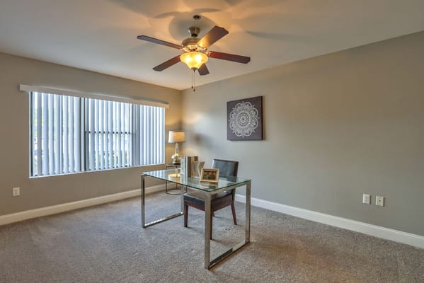 Brightly lit room with a desk and chair