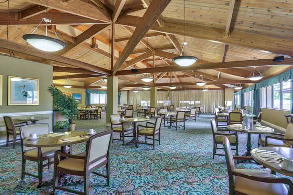 Bright dining room with wooden beams and tables
