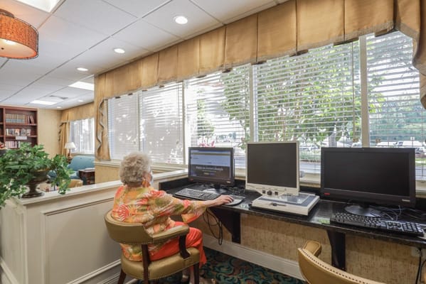 A resident using a computer in a common area