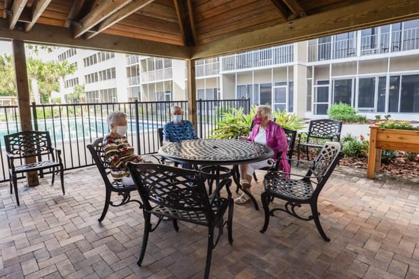 Three residents enjoying a conversation in an outdoor space