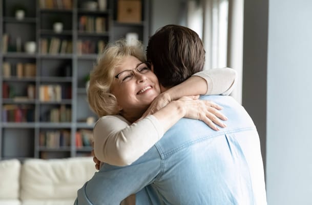 A joyful hug between a resident and a visitor