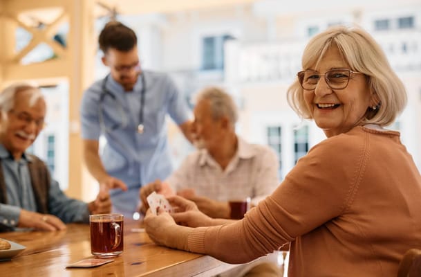 Residents enjoying a game of cards in a common area