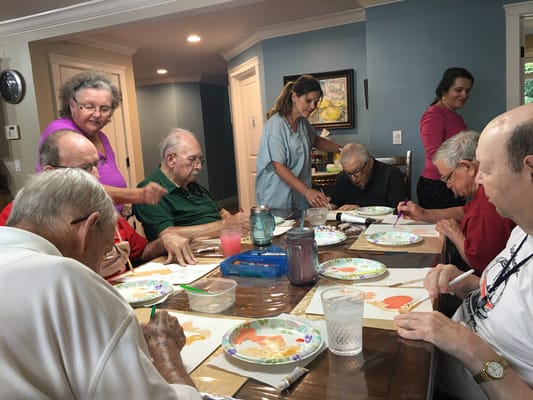 Residents and staff engaged in an art activity