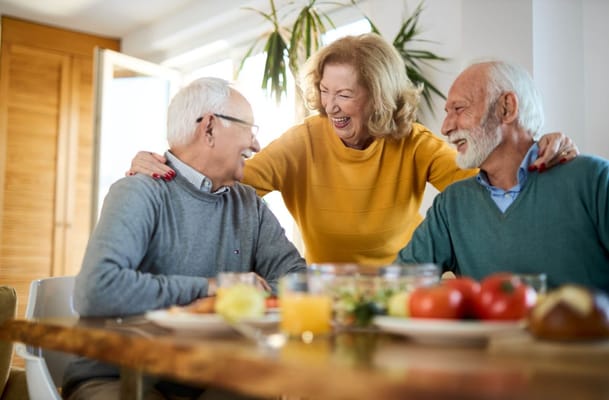 Residents enjoying a meal and laughter together