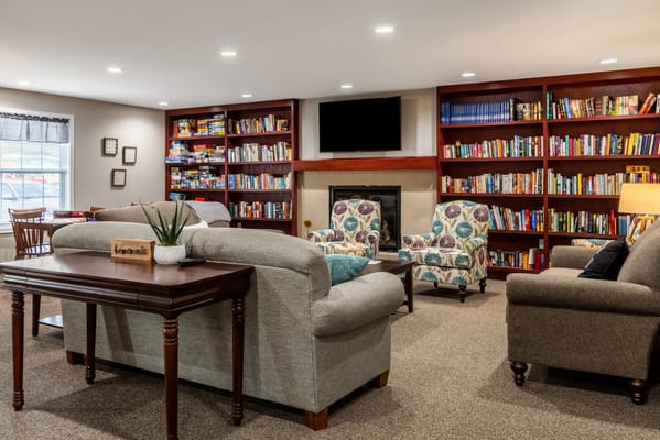 Cozy common area with seating and bookshelves