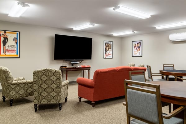 Interior common area with seating and a large TV