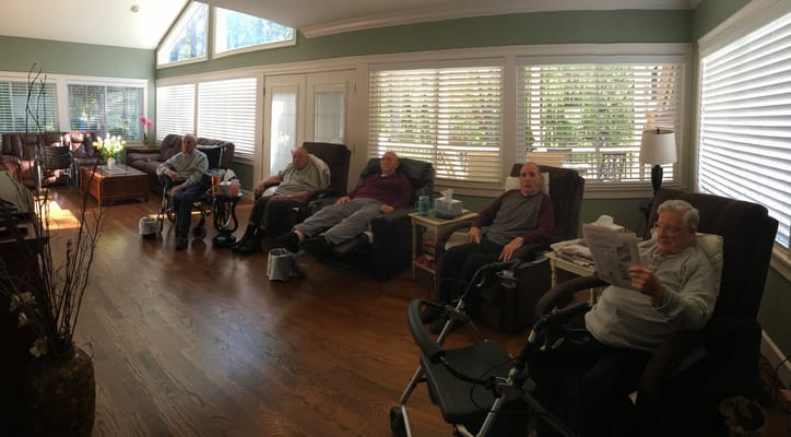 Residents relaxing in a sunny common area