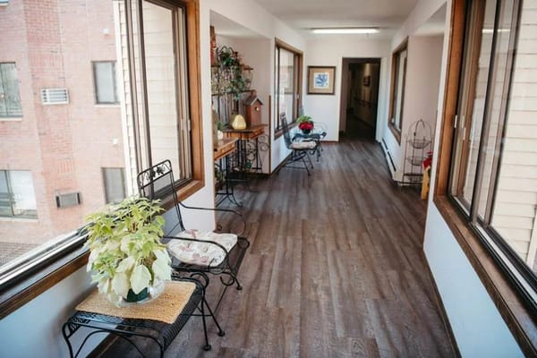Bright interior hallway with seating and plants