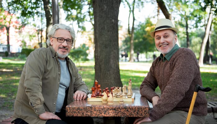 Two residents enjoying a game of chess outdoors