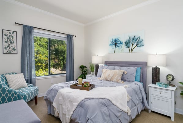 Brightly decorated resident room with flowers and cozy bedding