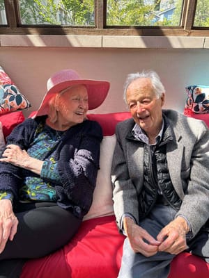 Two residents enjoying time together in a bright space