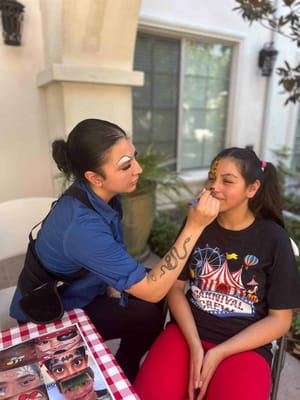 A resident getting face paint during an activity event