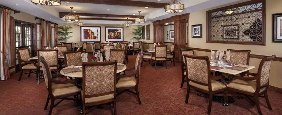 Dining room with tables and chairs set up for residents