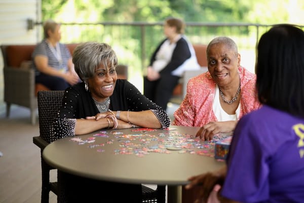 Residents engaged in a cheerful activity at a table