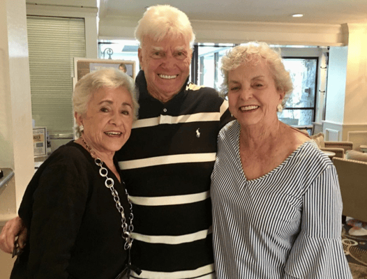 Three residents smiling in a common area