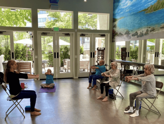 Residents participating in a seated exercise class
