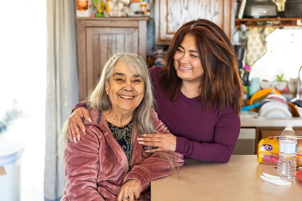 Residents enjoying a friendly moment in a cozy kitchen