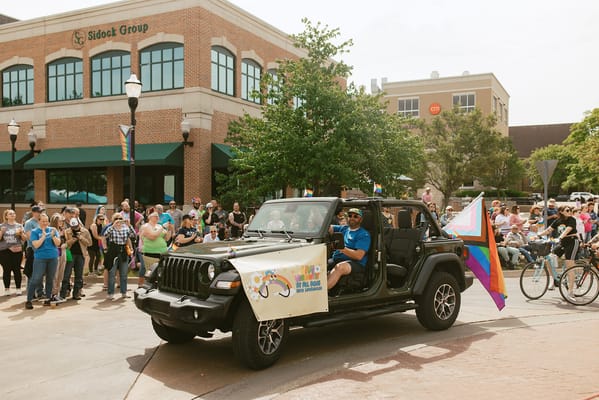Participants in a parade with a decorated vehicle