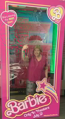 Senior resident enjoying a Barbie-themed decoration