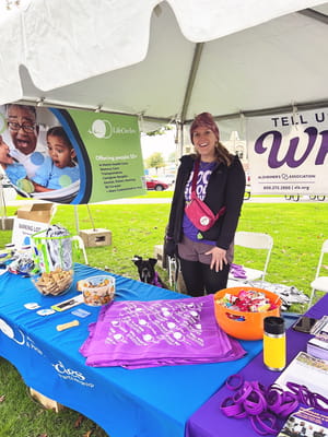 Staff member at an outdoor community event promoting LifeCircles.