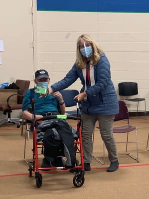 A staff member assisting a resident indoors