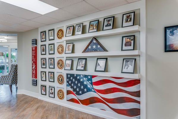 Interior wall display with an American flag and framed photos