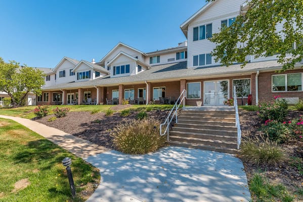 Exterior view of a senior living facility with landscaping