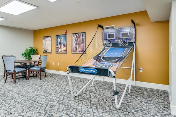 Common area with a basketball arcade game and seating