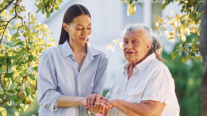 Caregiver and resident enjoying time outside together