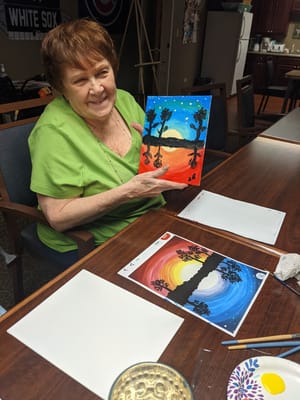 Resident painting during an art activity in the facility