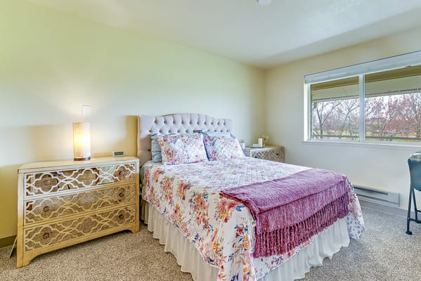 Cozy bedroom with floral bedding and natural light