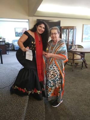Two women celebrating with a trophy in a common area