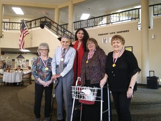Residents celebrating with medals in a common area