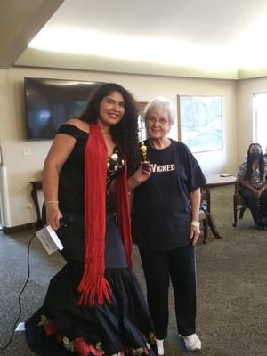 A resident and staff member at a celebration event