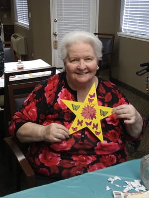 Resident crafting a star decoration with butterflies