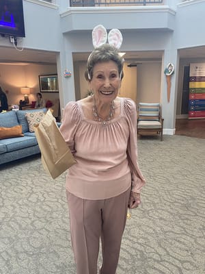 Resident celebrating with bunny ears in a common area
