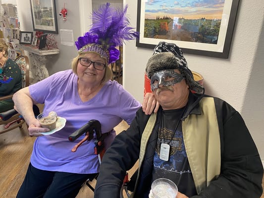 Residents celebrating with masks and snacks in a common area